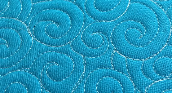 http://weallsew.com/wp-content/uploads/sites/4/2016/09/How-to-Free-motion-Quilt-Swirl-Designs-1110-x-600--555x300.jpg