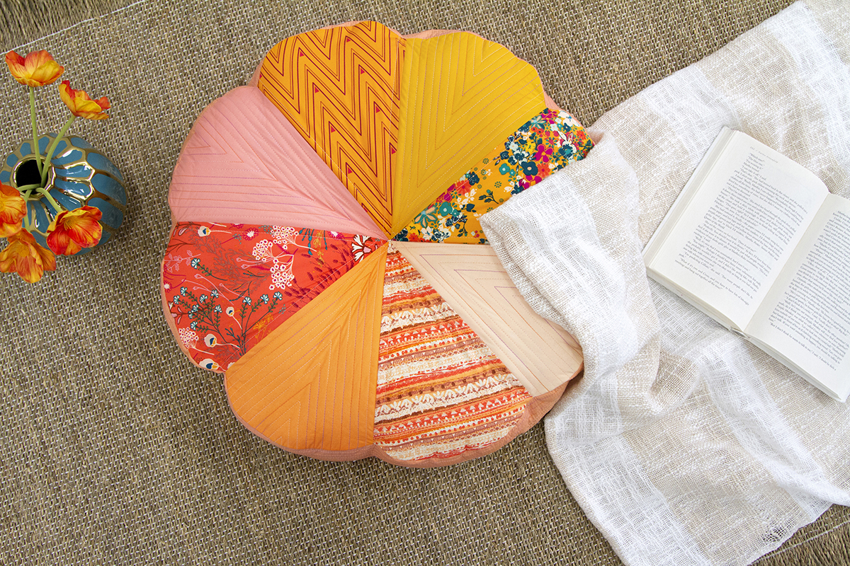 Hands pinning fabric layers together