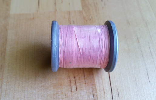 Tuck away loose thread ends on spools of thread
