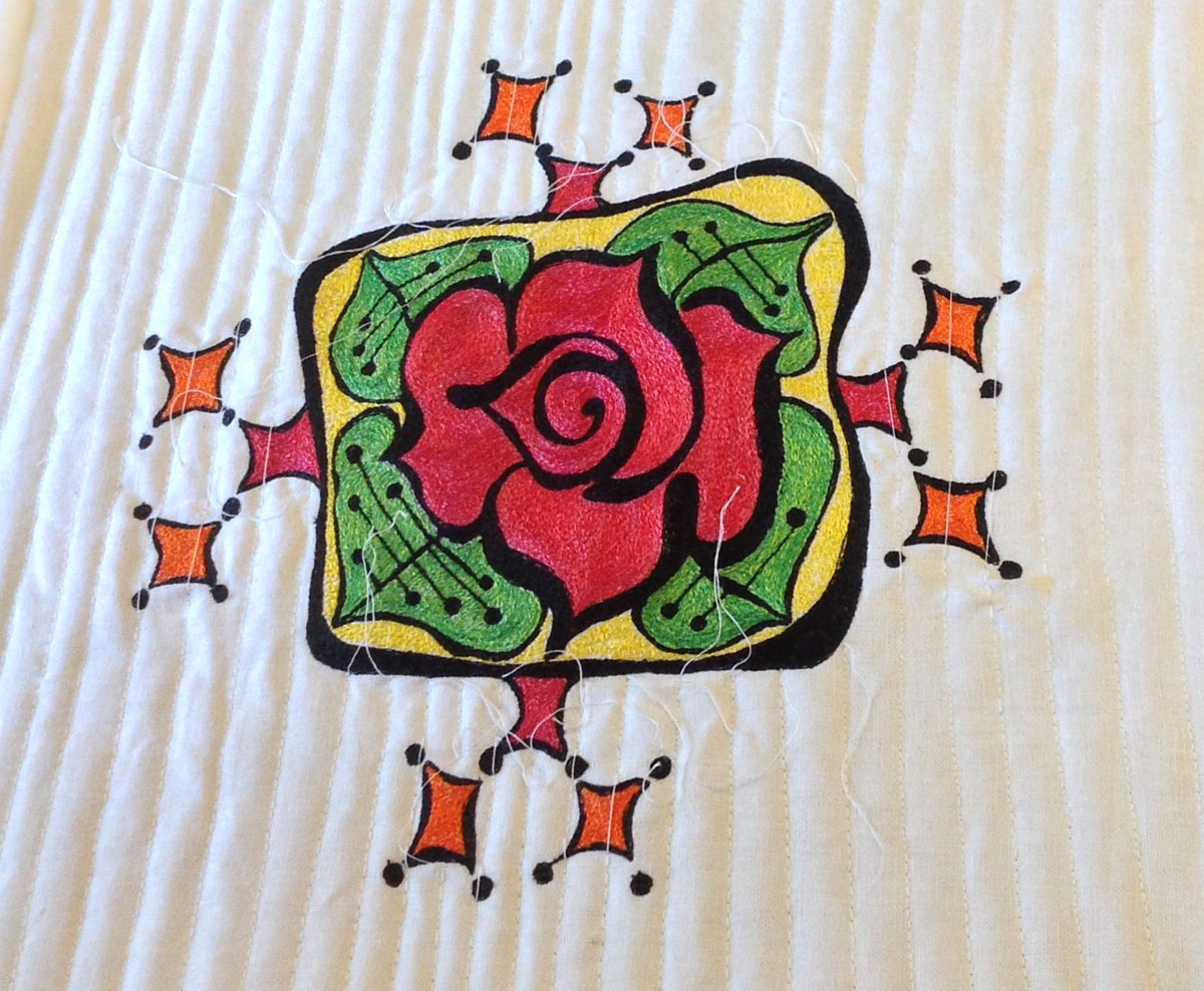 Add quilting to make a thread painted rose tile pillow
