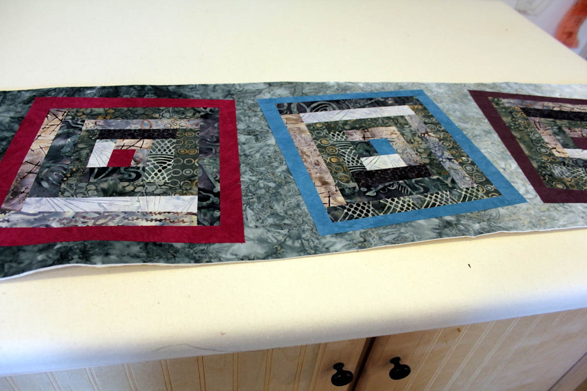 Fused Log Cabin Table Runner Tutorial - fuse blocks on top of background fabric