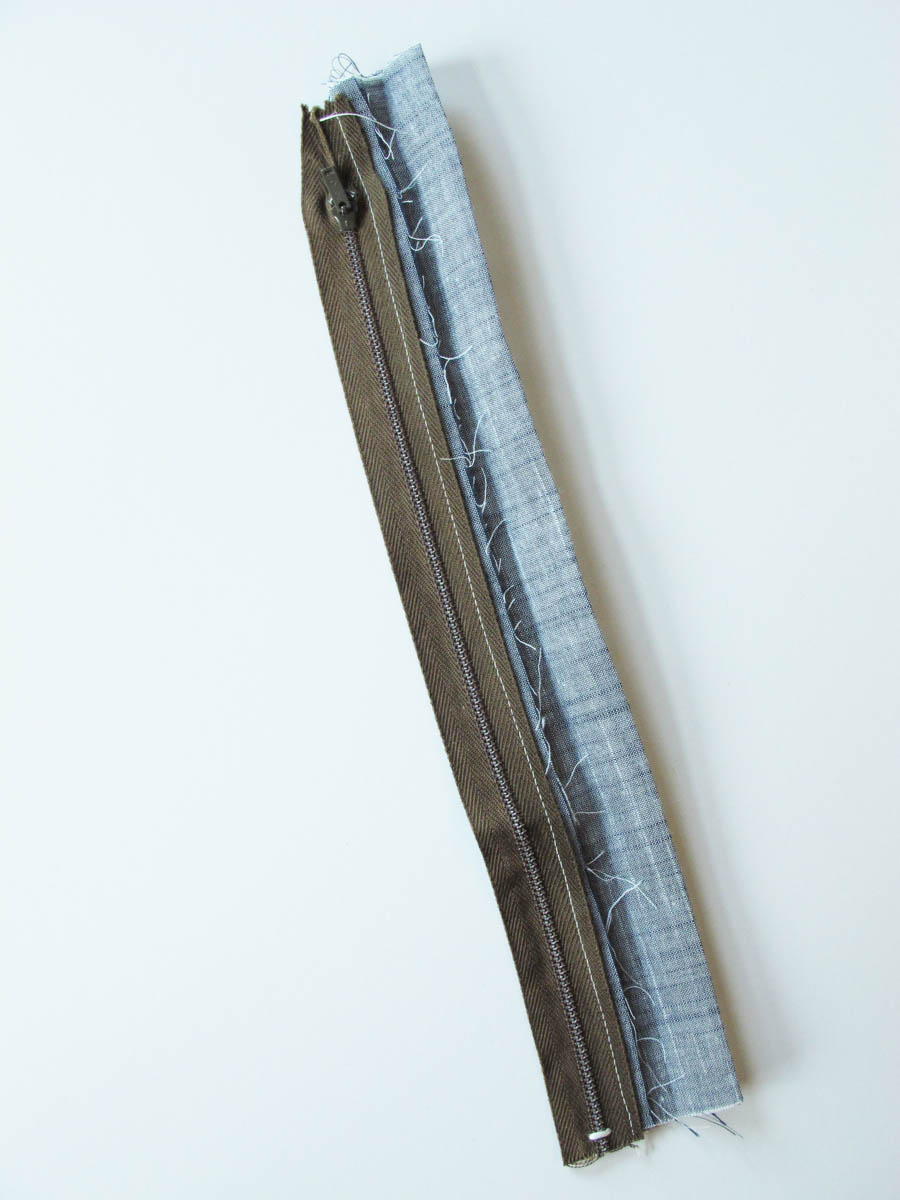 Vinyl Zip Pouch Tutorial - Press binding to front of the zipper