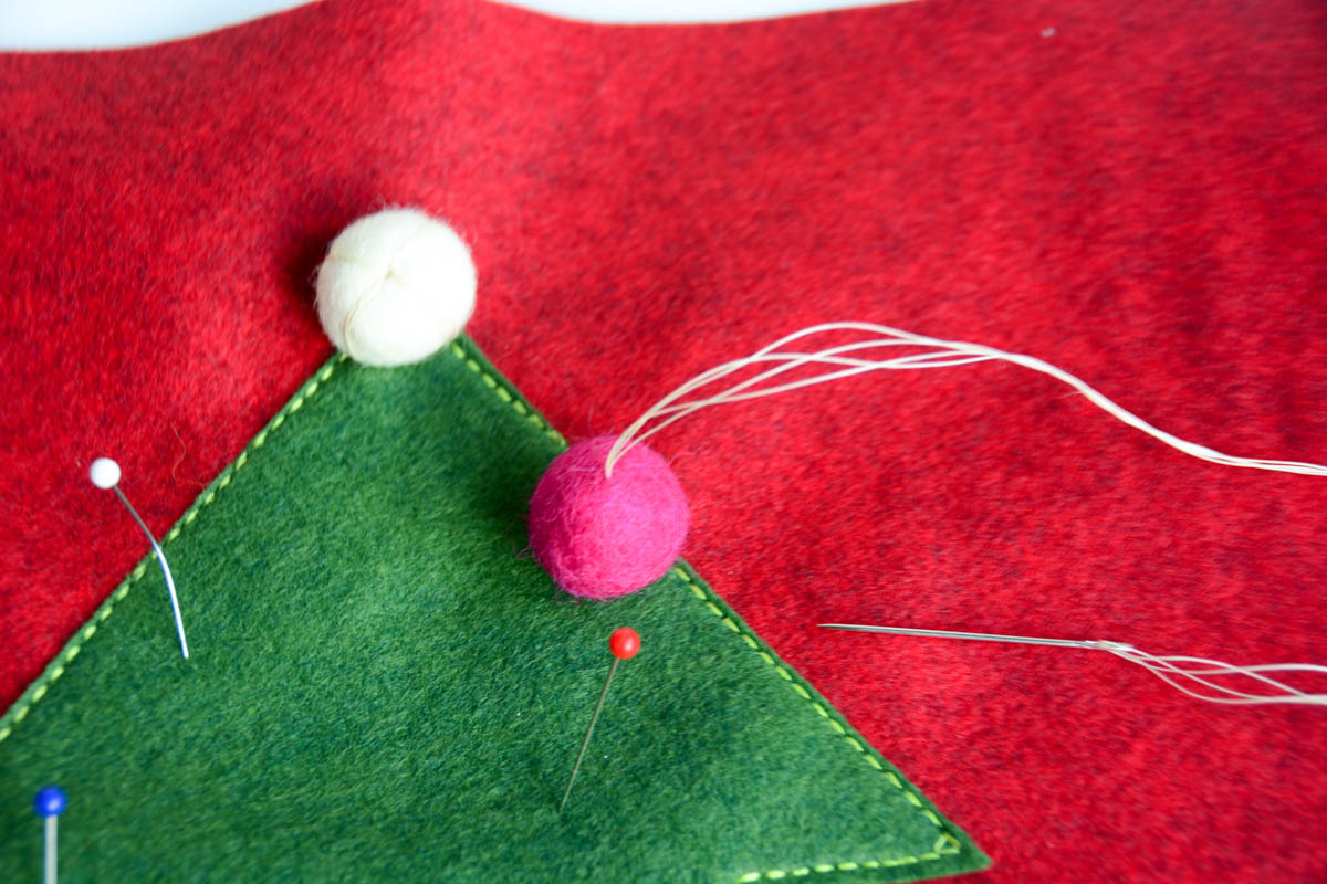 Christmas Tree Pillow Tutorial - Push the needle through the center of the pom pom