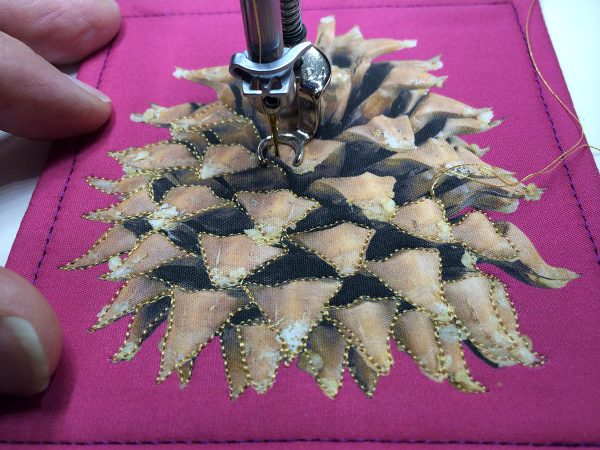Holiday Coasters Tutorial - stitch around the needles of the pine cone on the top side of the fabric sandwich 