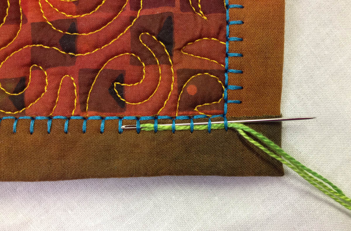 Embellishing the Blanket Stitch - needle under six stiches