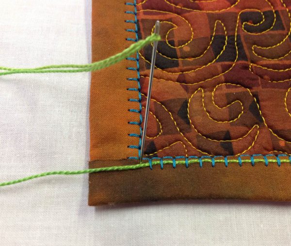 Embellishing the Blanket Stitch - needle at corner