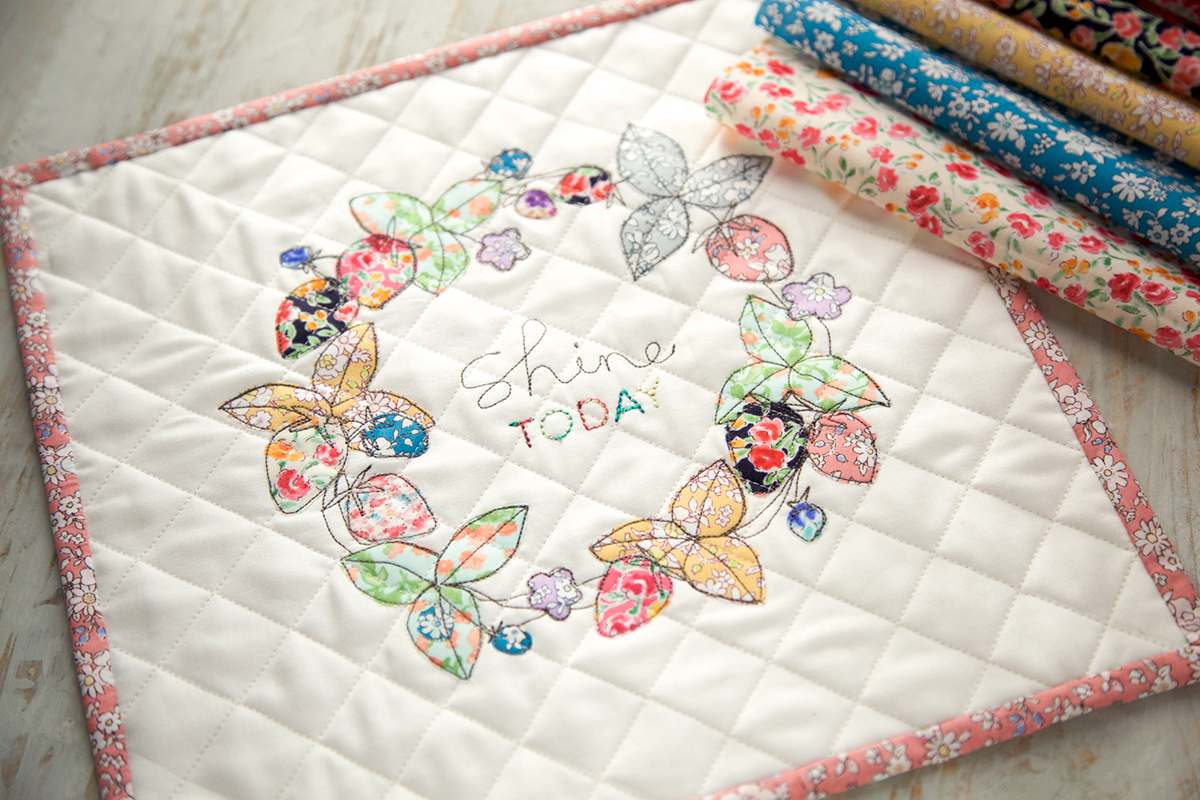 Embellishing a mini quilt with free motion and applique