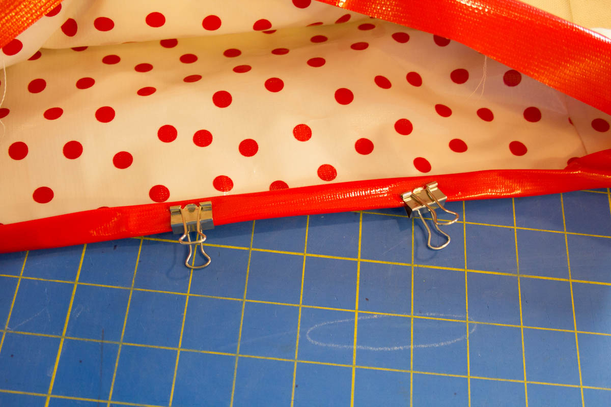 Oilcloth Garden Tote Tutorial - Use binder clips to hold the binding in place