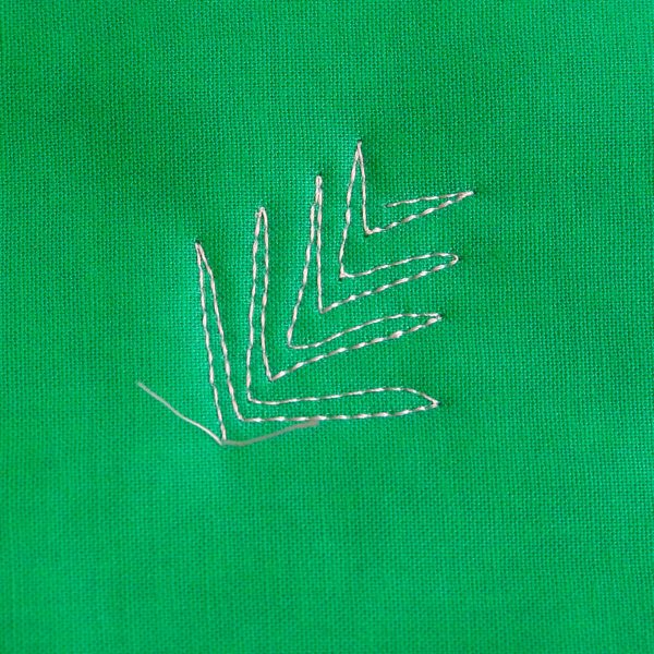 Free-motion Quilting Pine Boughs and Holly- stitch shorter lines so the bough tapers at the tip