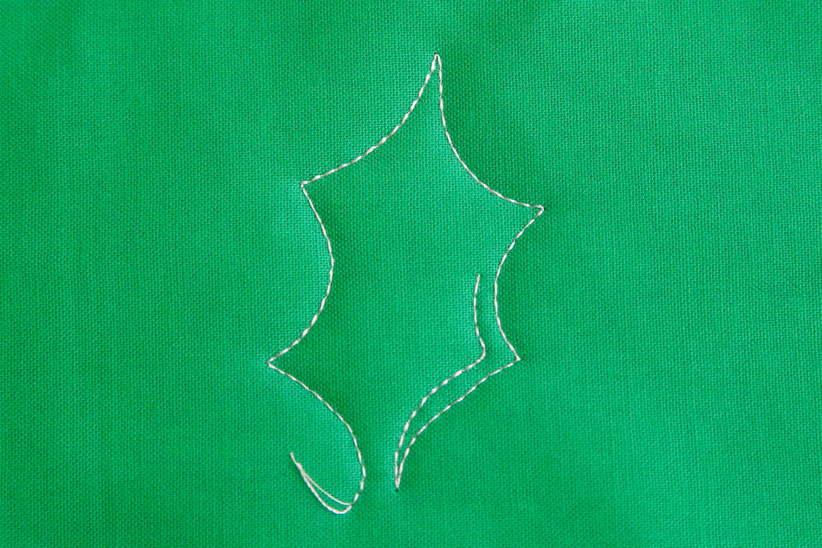 Free-motion Quilting Pine Boughs and Holly-Begin echo stitching the inside of the Holly Leaf.