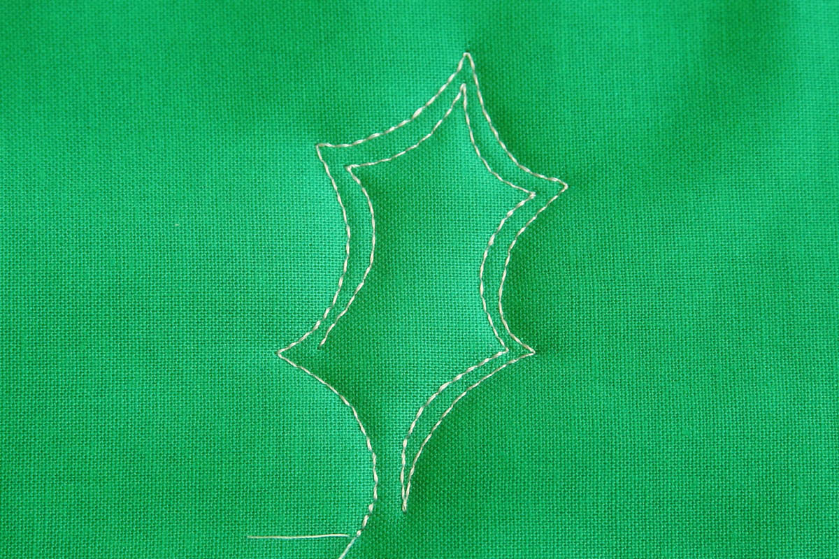 Free-motion Quilting Pine Boughs and Holly-Echo Stitching on the inside of the leaf
