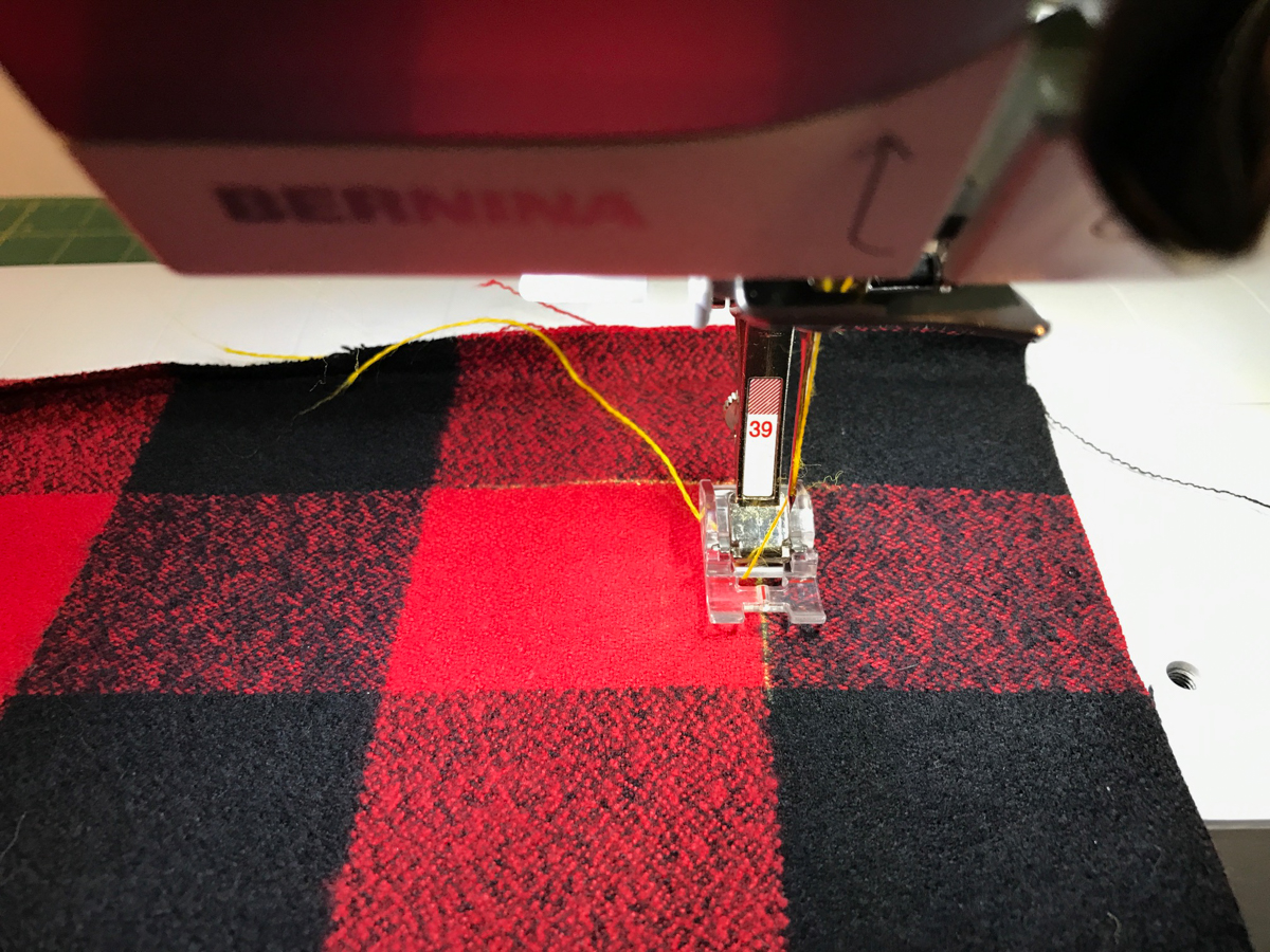 DIY Blanket Scarf-Start sewing aligning the center mark of the presser foot along a line in the plaid