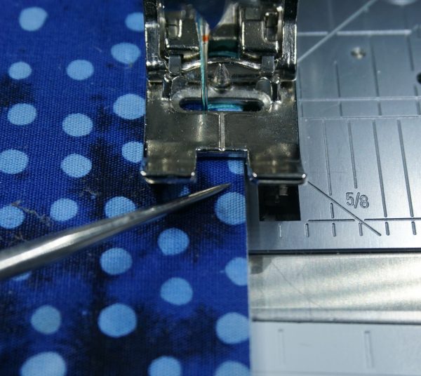 align the edge of your fabric with the inside edge of the foot