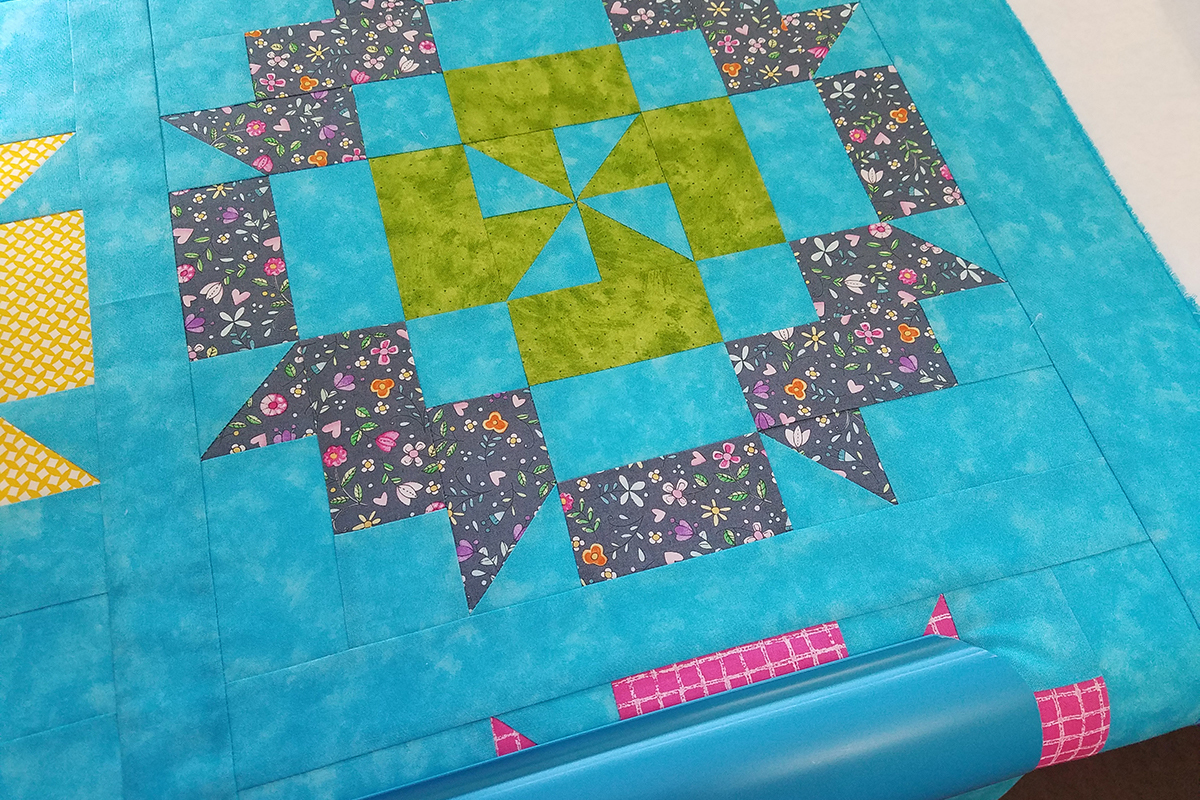 Straight Line Quilting with Q-matic, load quilt