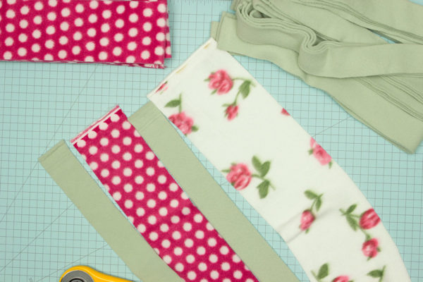 This Scrappy Fleece Blanket Tutorial is fast easy and frugal. With a few simple tools and a free evening you can make a large fleece blanket.
