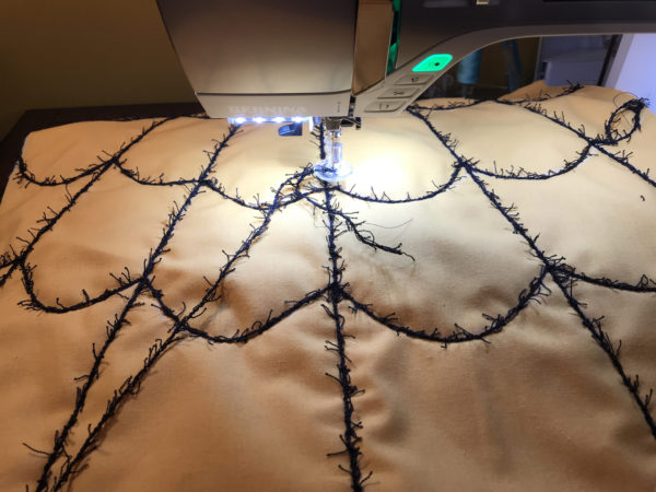 Spider Web Door Banner tutorial WeAllSew Blog - Add three long, stitched yarn lines