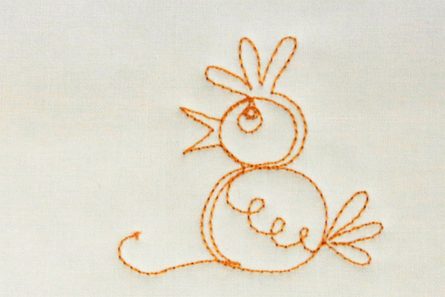 Free-motion stitched baby chick motif