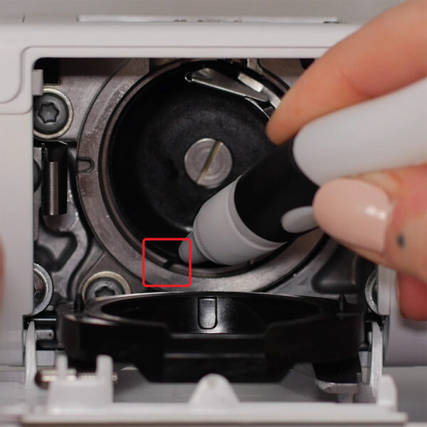 How to Clean and Oil Sewing Machines with a CB Hook - Hook Cleaning - remove the needle - remove the stitch plate - release bobbin case - bobbin case removed - dust out your machine - cleaning with a soft cloth - apply a drop of oil