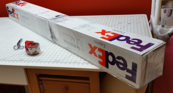 FedEx boxes combined to form a long rectangular box for the quilt