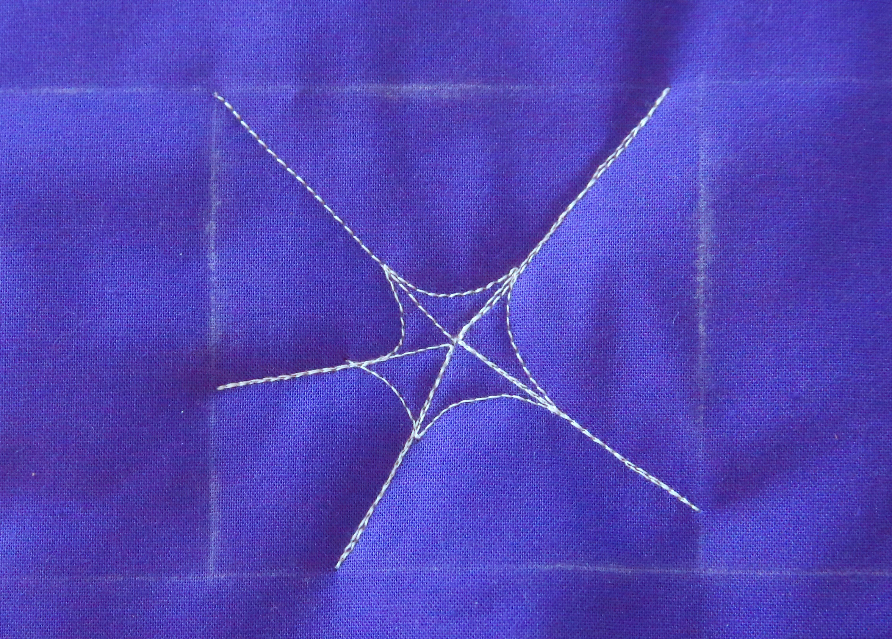 How to free-motion quilt a spider web and spider - step four