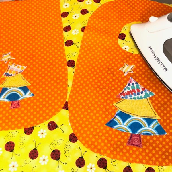 Appliqued Bib Burp Cloth Set Tutorial: fusible applique pieces in place