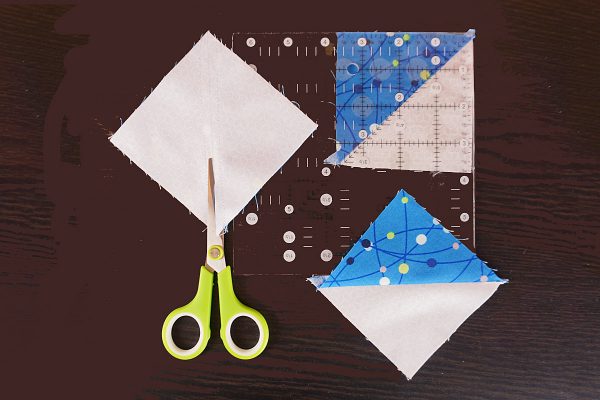 Star of David Hanukah Mug Rug cut apart half square triangles and press opened, trim