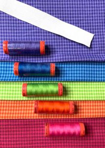 Rainbow colored fabric with coordinating thread and elastic for the Tiered Maxi Skirt Tutorial