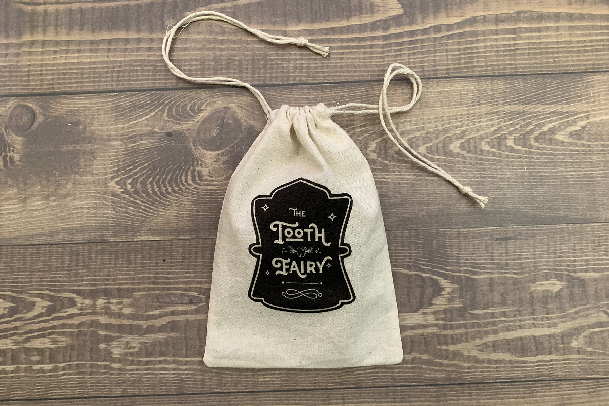 Tooth Fairy Drawstring Pouch Pattern: Small muslin drawstring pouch with a decal that reads, "The Tooth Fairy"