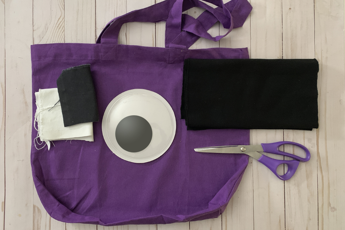Materials to sew the Eye on You Treat Bag: Pre-made tote (purple), large, 6-inch googley eye, scraps of both black and white fabric for matching appliqué, coordinating thread.