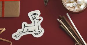 Machine embroidered feltie featuring a stylized reindeer design.