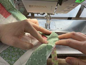 Binding a corner for the Nona Quilt Along BERNINA WeAll Sew blog