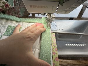 Binding a corner for the Nona Quilt Along BERNINA WeAll Sew blog