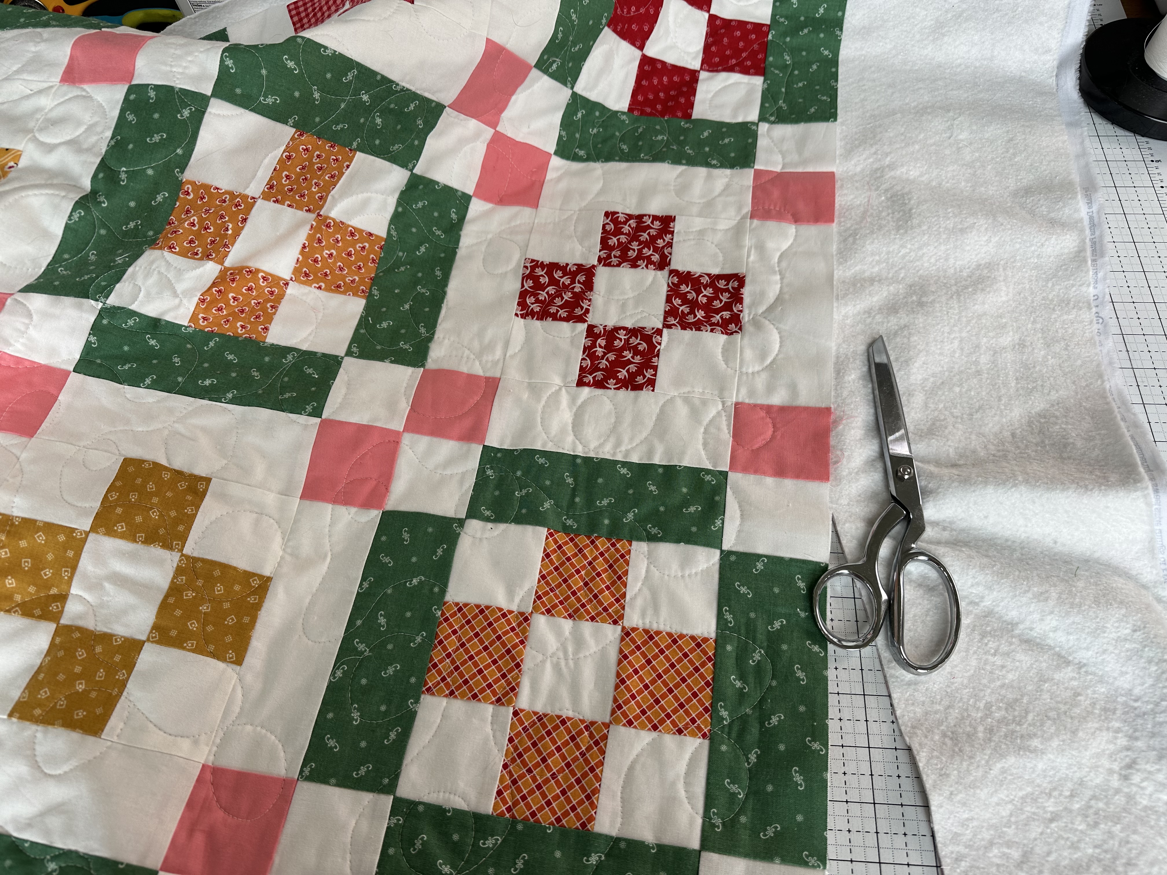 Trimming excess batting and backing from the Nona Quilt Along BERNINA WeAll Sew blog