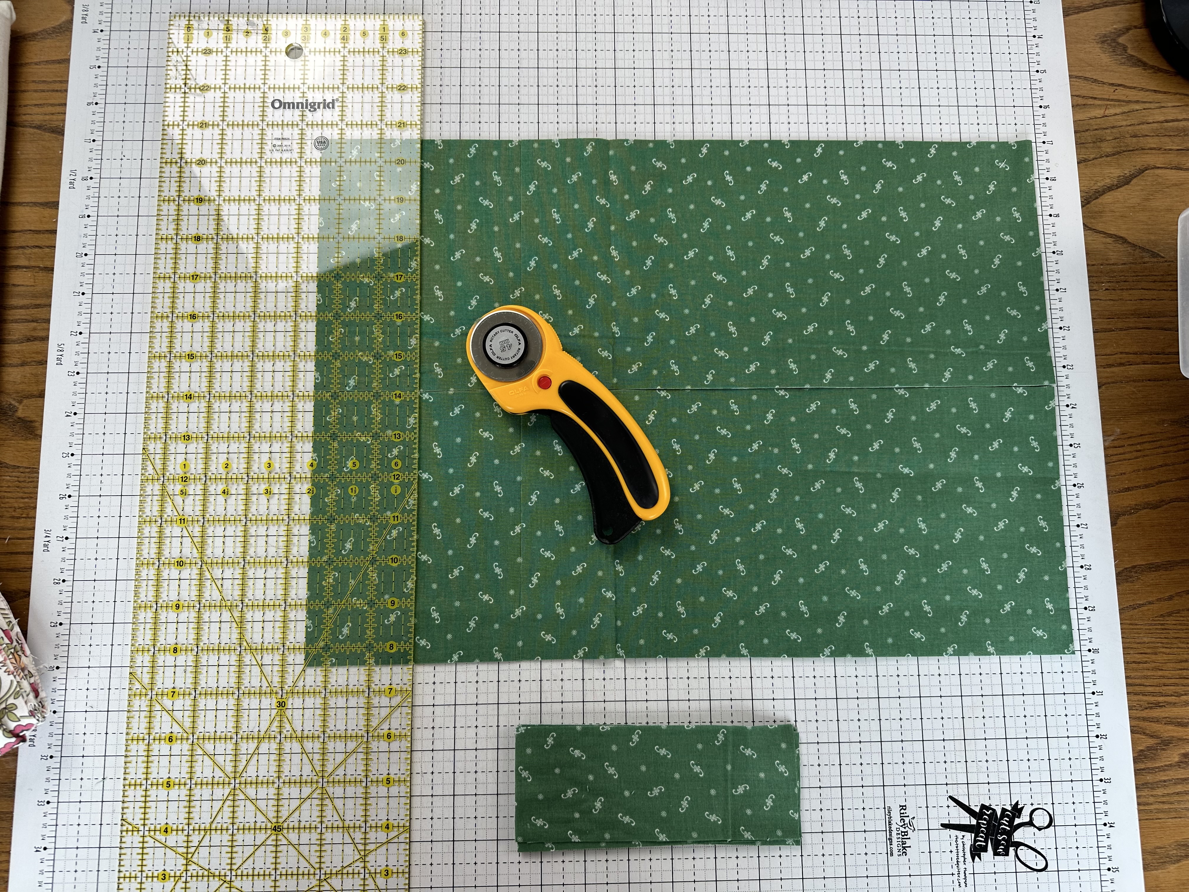Cutting the Alpine fabric yardage with a ruler and rotary cutter