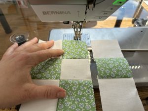 Assembling the rows of a Nine Patch for the Nona Quilt Along BERNINA WeAllSew blog