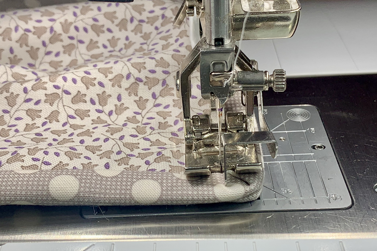 Serger_Baby_Quilt_#3_Post_33_guide_on_top_of_binding_BERNINA_WeAllSew_Blog_1200x800px