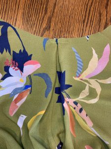 A pleat basted in the coat lining back