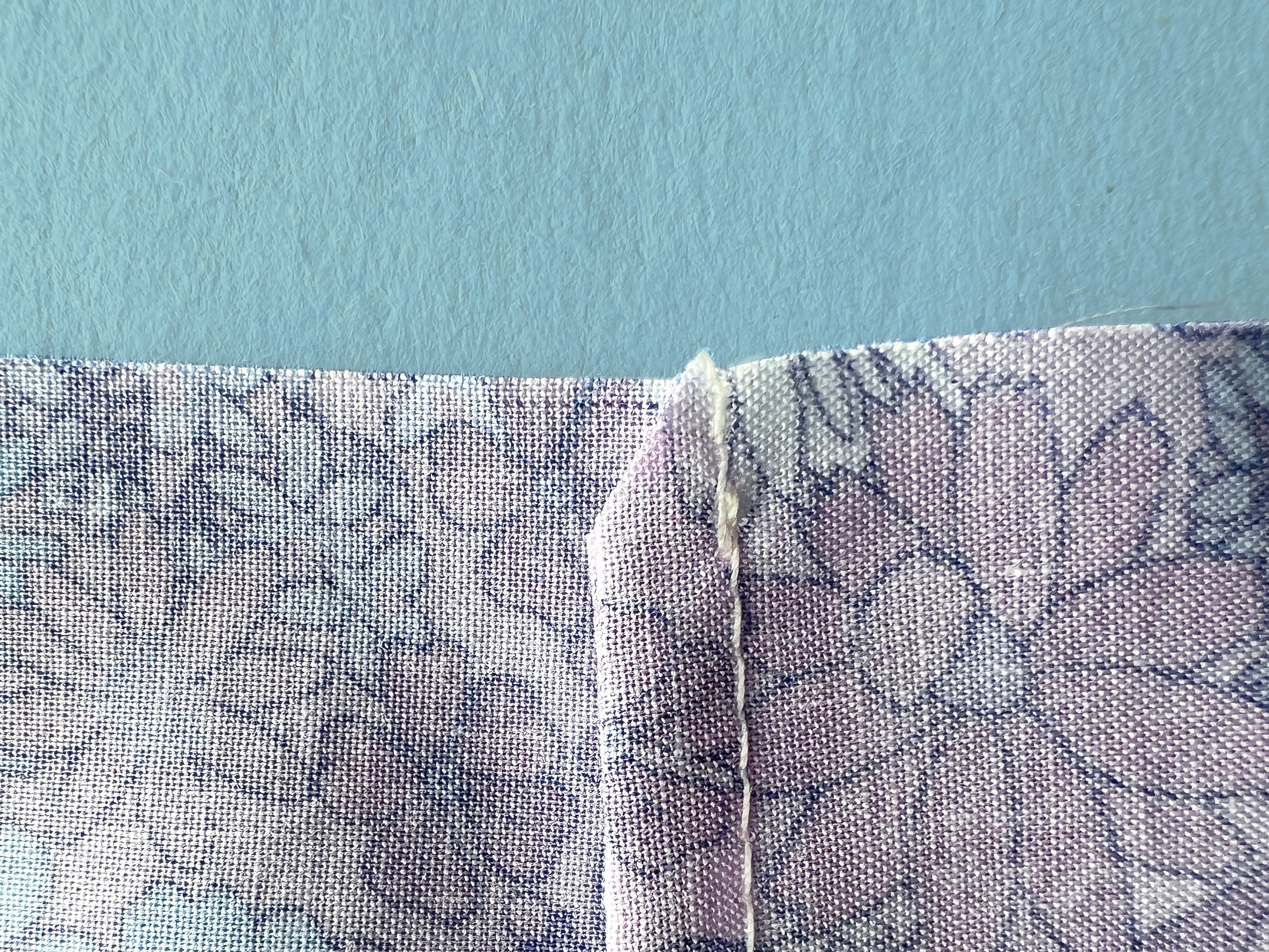 A French seam has been pressed to the side and clipped at an angle.