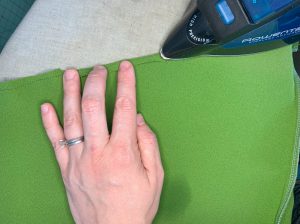 Ironing the skirt hem along the stitched guide