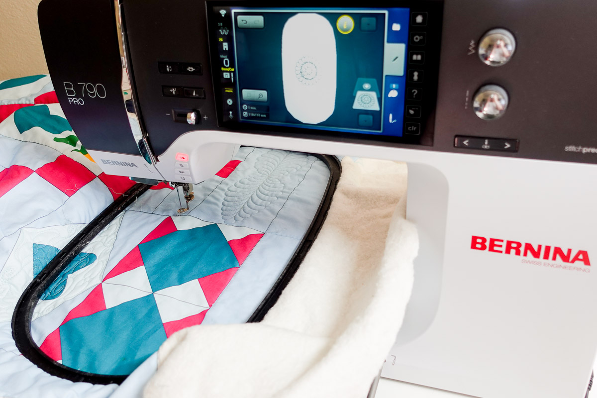 the black inner hoop is placed onto the Jump for Joy quilt under the needle of the B 790 PRO.