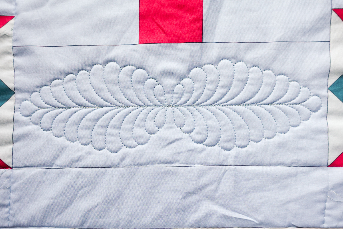 Closeup of the quilted design on a light blue fabric, using the B 790 Pro computerized quilting capabilities.