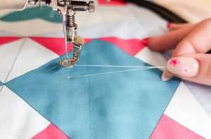 Using the needle function to set the bobbin thread to begin quilting