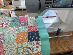 Sewing mat top to the backing