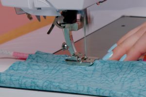 Sewing inserted piping; Piping, inserted into blue fabric, being sewn on a BERNINA sewing machine.
