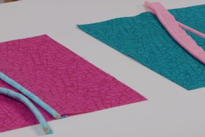 side view of 2 cords sewn on 2 different machines.