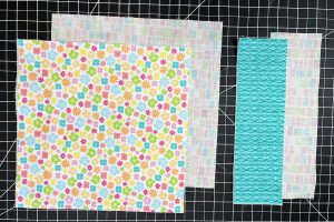 overhead view of floral and teal fabric pieces.
