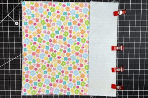 overhead view of floral fabric clipped to a rectangle piece of fabric.