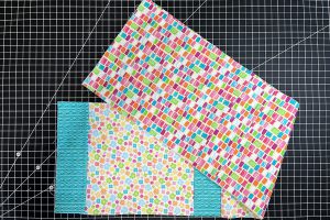 overhead view of multi-color fabric squares sewn together.