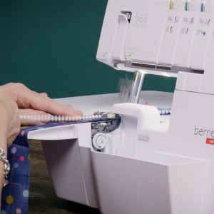 white beds being sewn onto a blue fabric strip using the b68 AIRLOCK