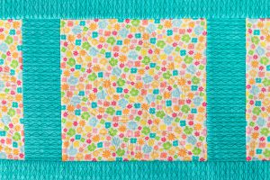 overhead view of embroidery on multi-color fabric